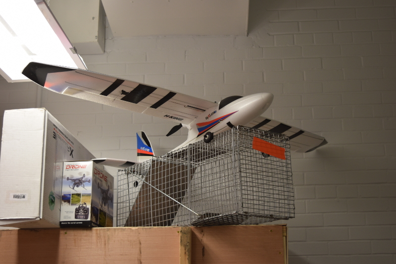 A traditional model airplane on top of a filing cabinet