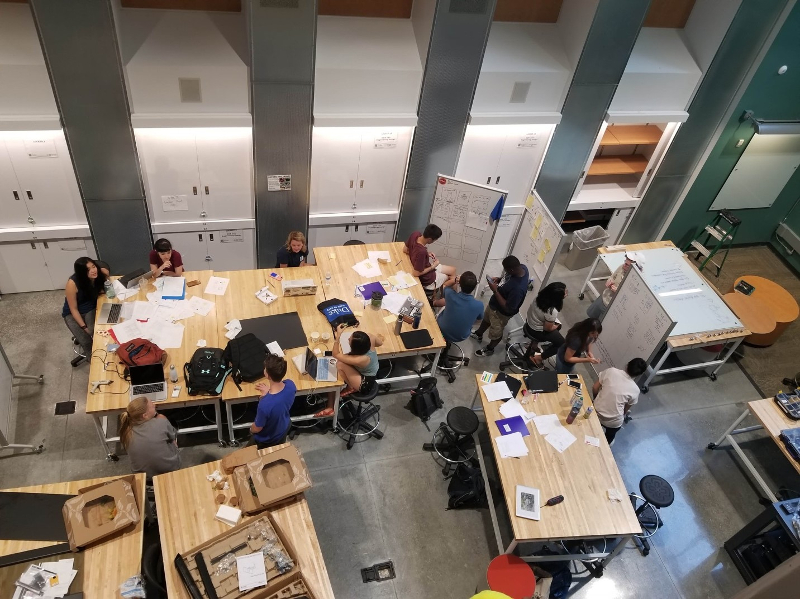 A top-down view of a bunch of students working in a large open space