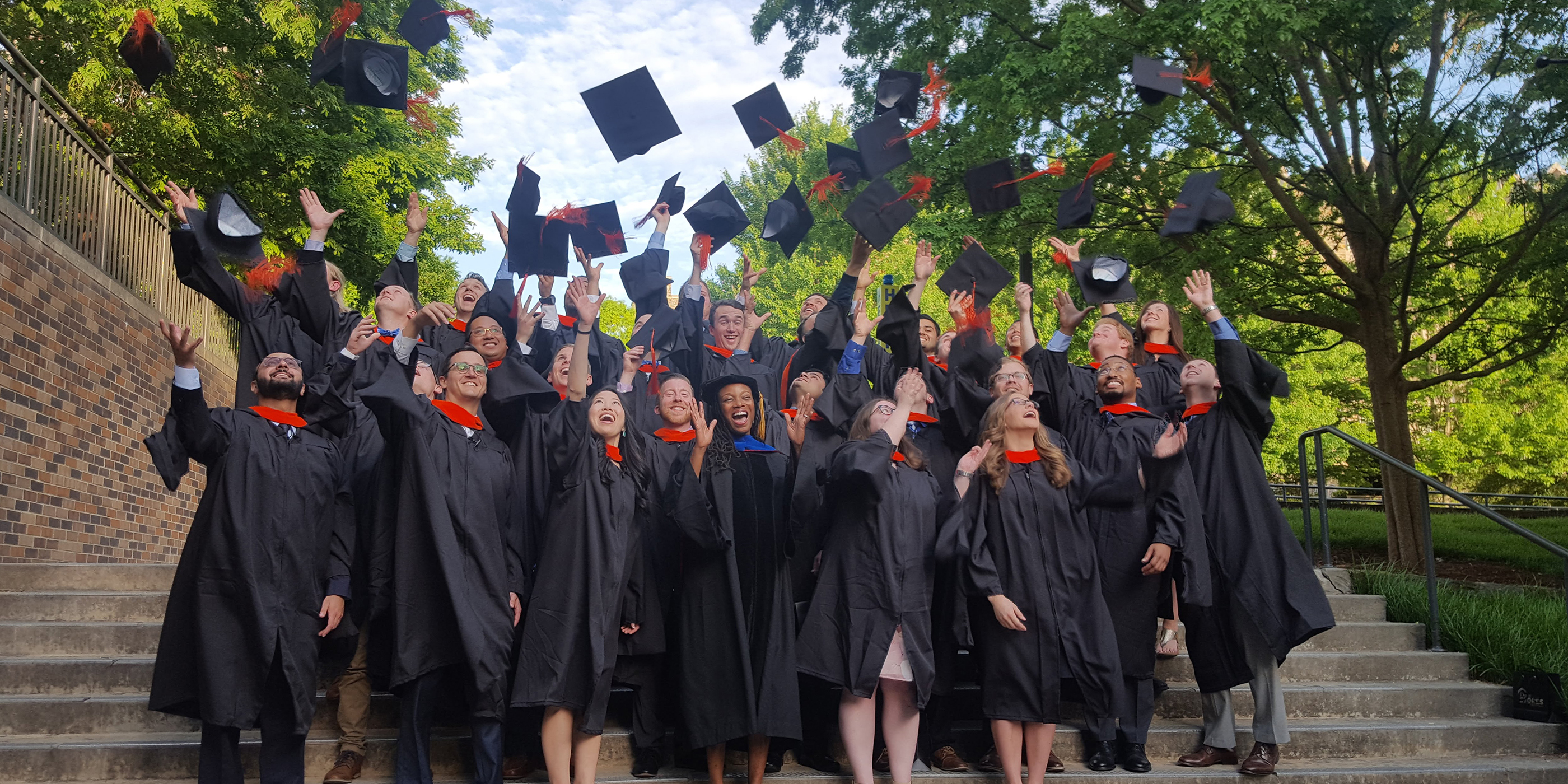 Graduating Duke MEMP students throw their caps in the air