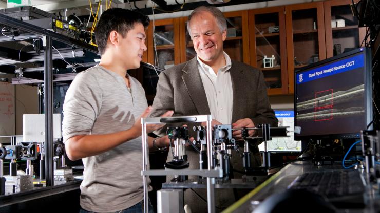 Professor Joe Izatt with student in photonics lab