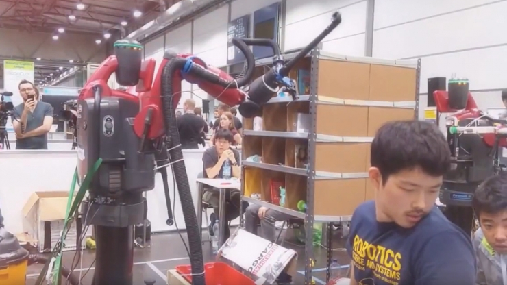 Yilun Zhou works with the team’s picking robot at the Amazon Picking Challenge in Leipzig, Germany.