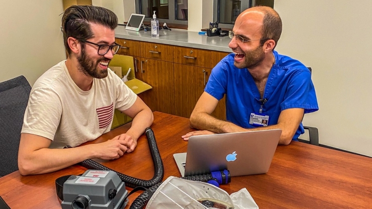 Design Health Fellows Alejandro Pino (left) and Konstantinos Economopoulos (right) collaborating on a presentation for the PAPR Bridge Project. Picture taken by Theresa Thompson