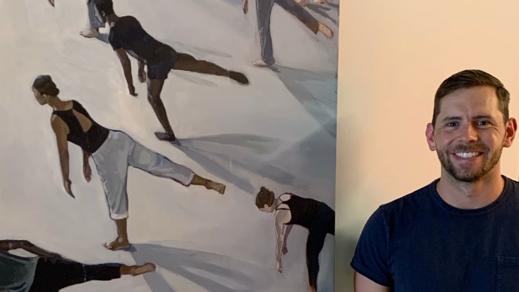 Clay Sanders next to painting of dancers