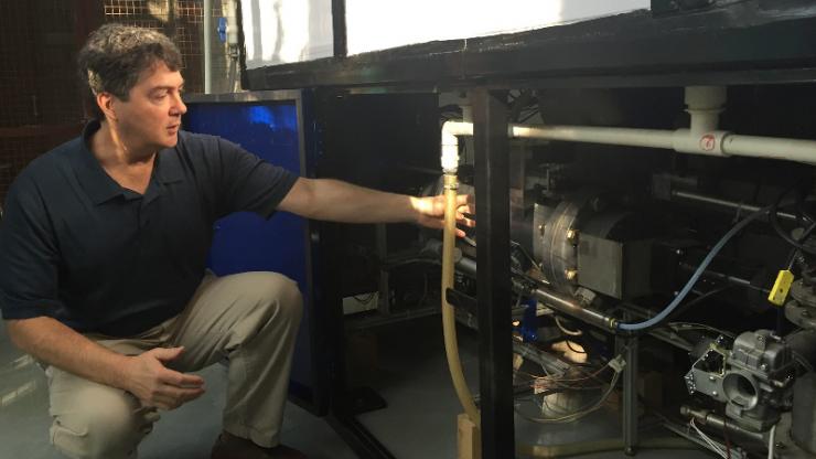 Brian Stoner, seen here with one of the prototype sanitation systems, is leading Duke's sanitation technology cluster