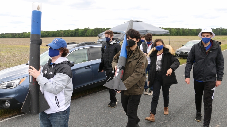 Duke University mechanical engineering students approach site to launch rocket