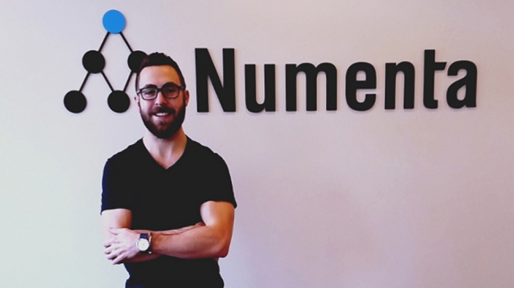 Alexander Lavin in front of a Numenta sign