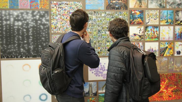 Students peruse entries in AI art competition