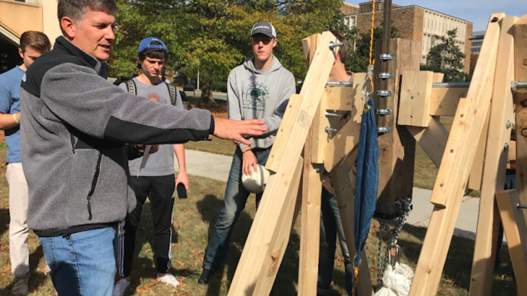 David Schaad demonstrates how to use a trebuchet to his engineering class 