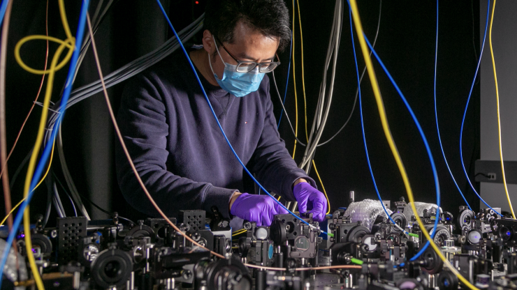 Lu Qi, an Electrical and Computer Engineering Postdoctoral Fellow in the Brown Lab works on a quantum computer setup.