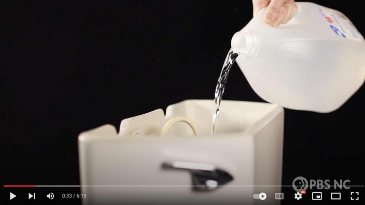 milk jug filling a toilet tank