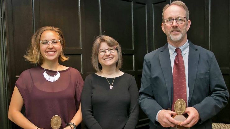 Sullivan Award winners Lauren Harper, left, and Rick Hoyle, right, received their awards from Provost Sally Kornbluth, center. 
