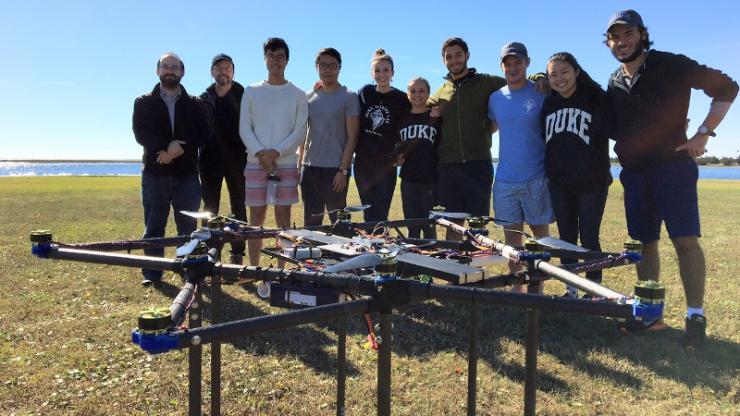 Duke Engineering students stand with their prototype heavy-lifting drone after a test flight for the Ocean Discovery XPRIZE competition.