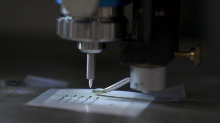An ink jet printer printing silicon electronic onto a plastic sheet