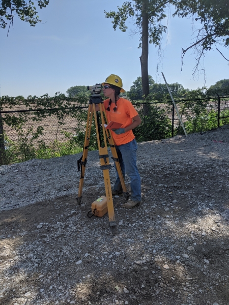 Caroline Heitmann using surveying equipment