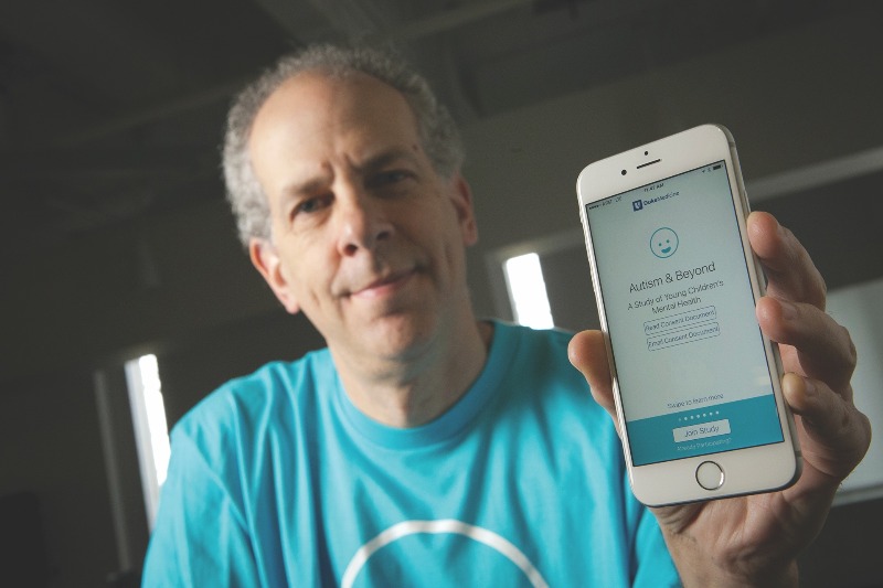 Guillermo Sapiro with autism app on phone