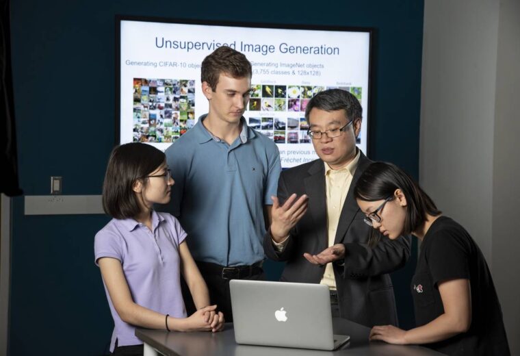 Yiran Chen with students at computers