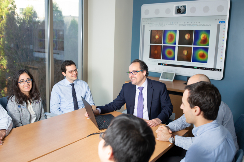 Filipe Medeiros with his research team around a table