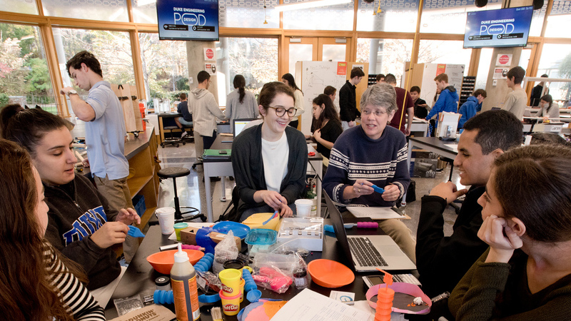 Duke Engineering students and Prof. Ann Saterbak working in the Duke Engineering Design Pod.