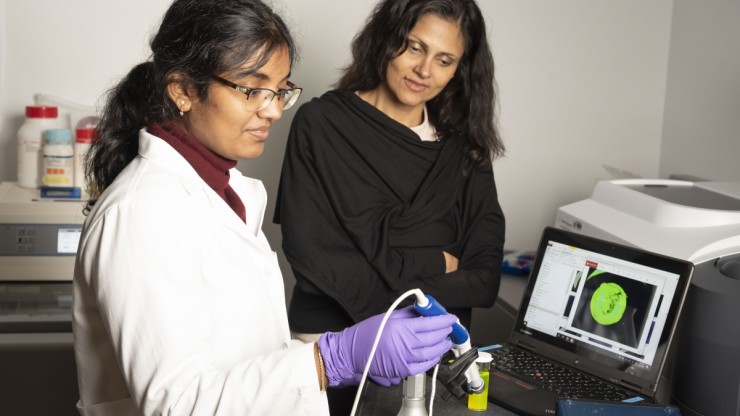 PhD student Enakshi Sunassee images a fluorescent specimen by using optical technology that was developed by the Center for Global Women's Health Technologies. All photos by Les Todd