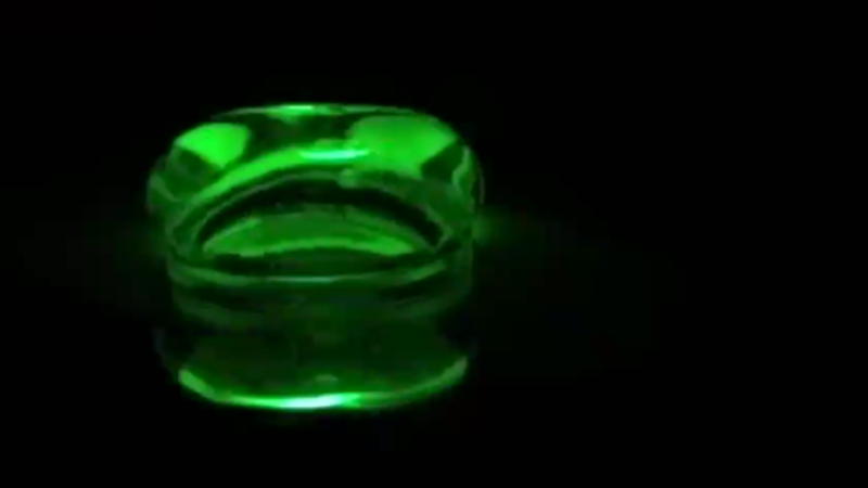 A neon green, semi-transparent, pill-shaped blob