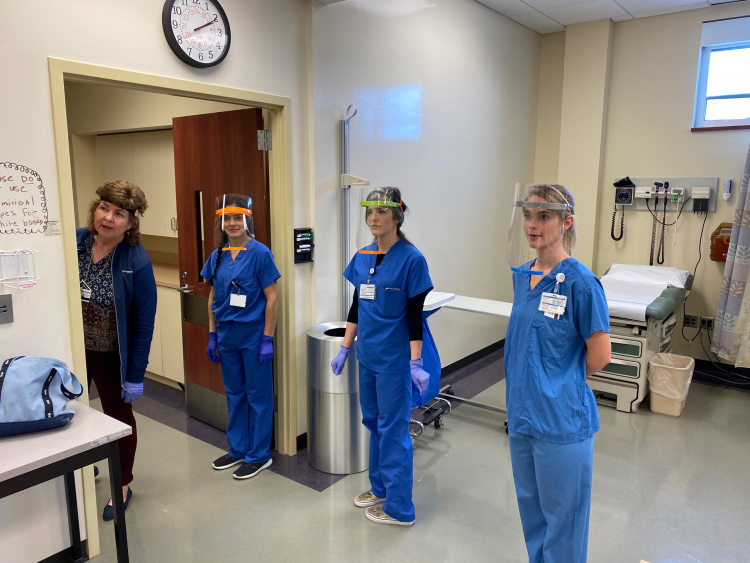 nurses standing six feet apart with face shields on