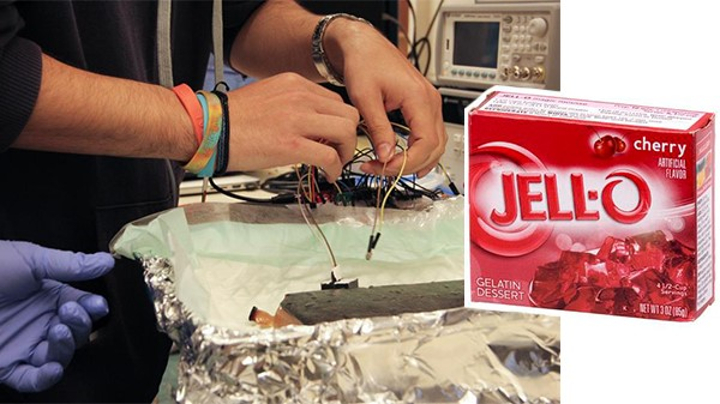 A pair of hands works with jello in a kitchen