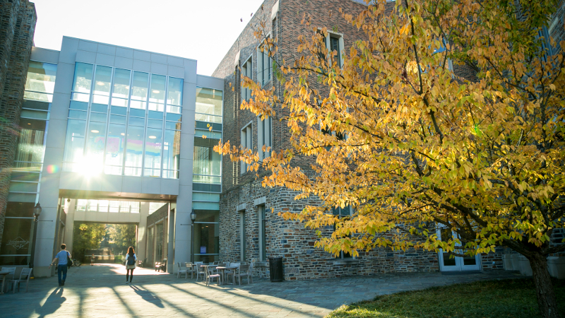Early morning sun shines through the Fitzpatrick Center for Interdisciplinary Engineering, Medicine and Applied Sciences (FCIEMAS) as surrounding foliage begins its colorful transition through Fall.