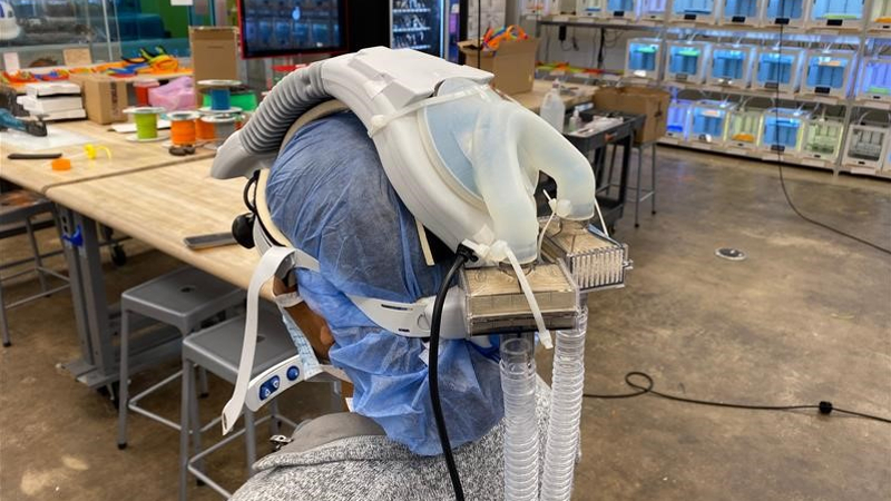 The back of a surgeon's head with a big plastic machine on it