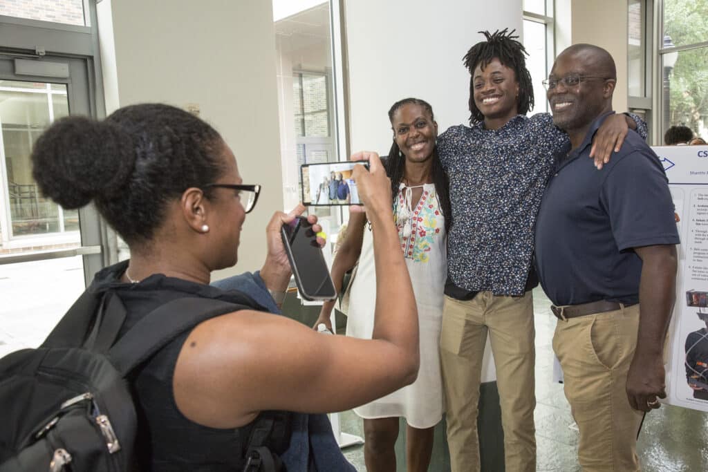a person takes a photo of three people