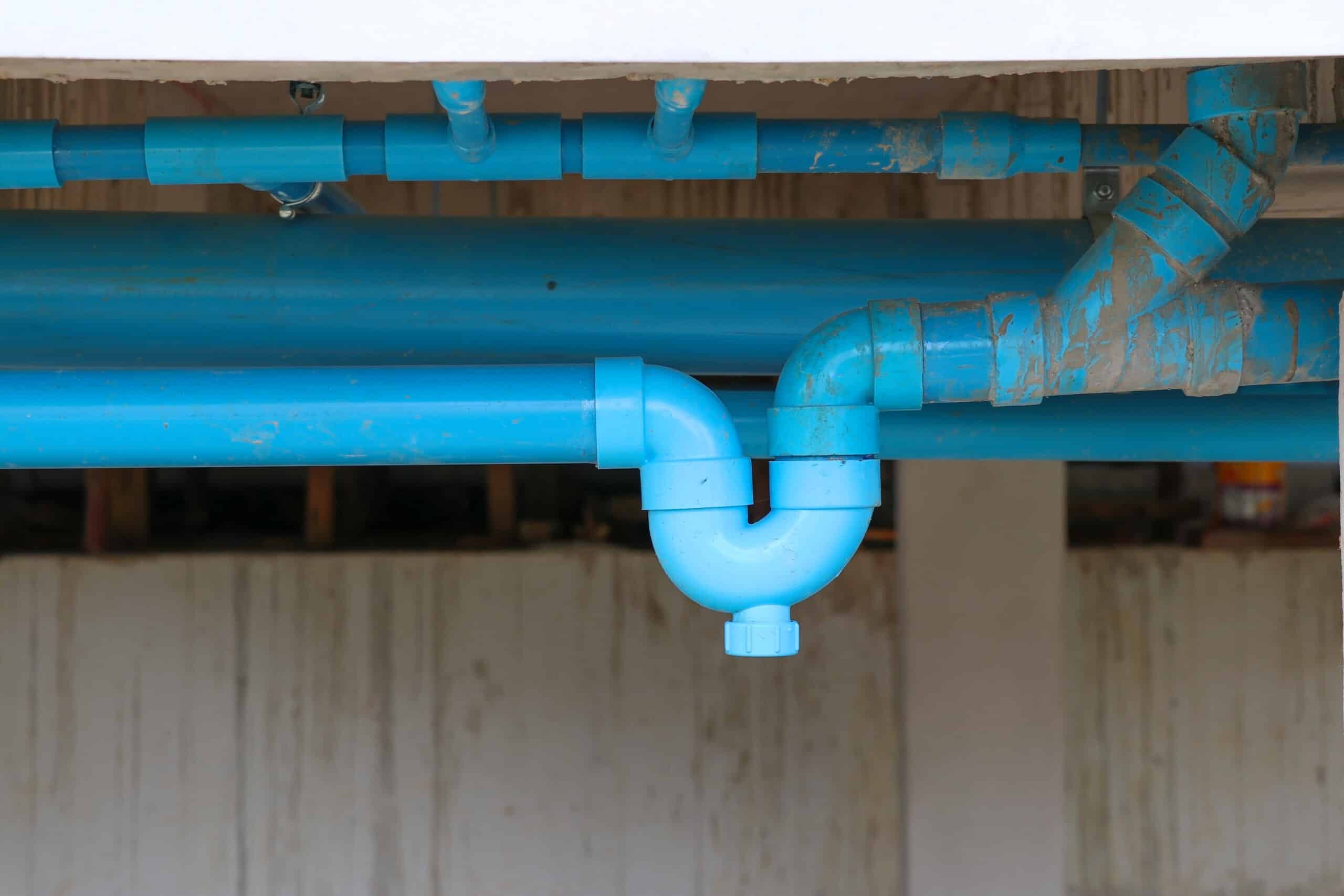 Blue P-trap pvc for reverse odor protection. Blue sanitary P-trap installed at site construction.