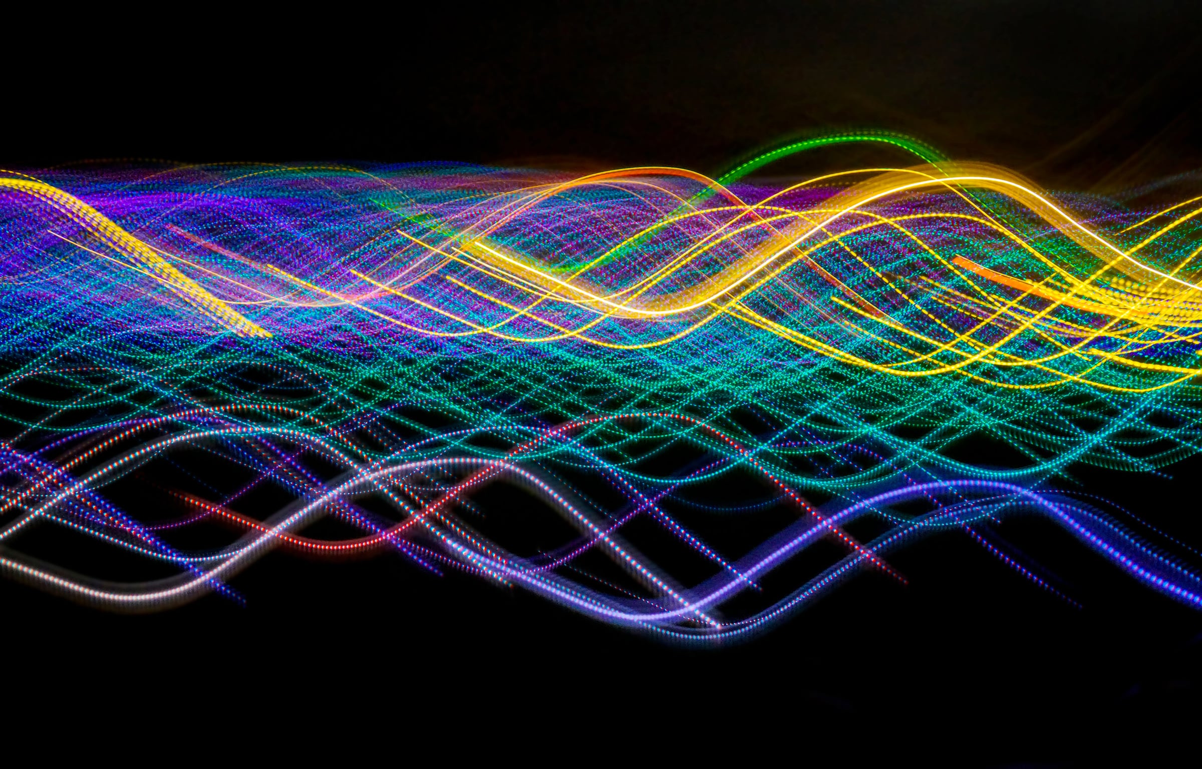 Colorful laser lights in motion flowing in a pattern.