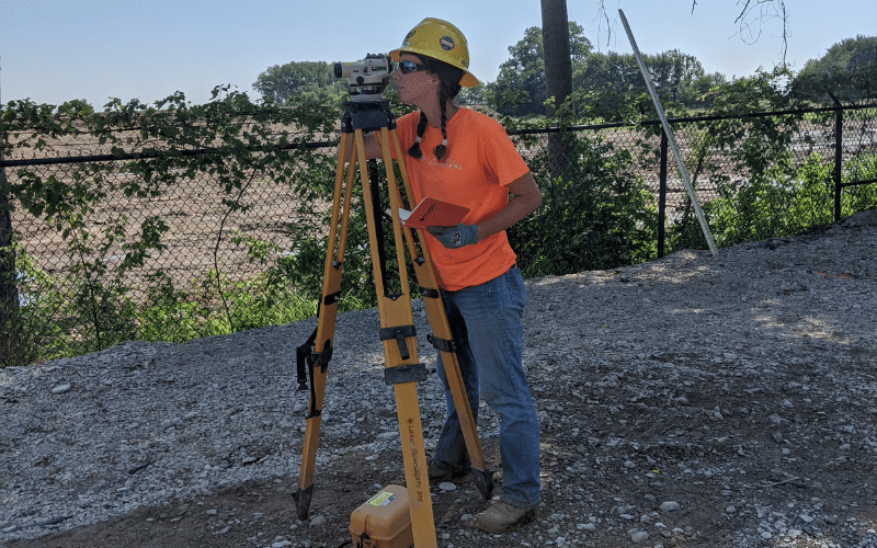 Caroline Heitmann using surveying equipment