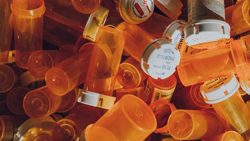 a pile of pill orange pill bottles
