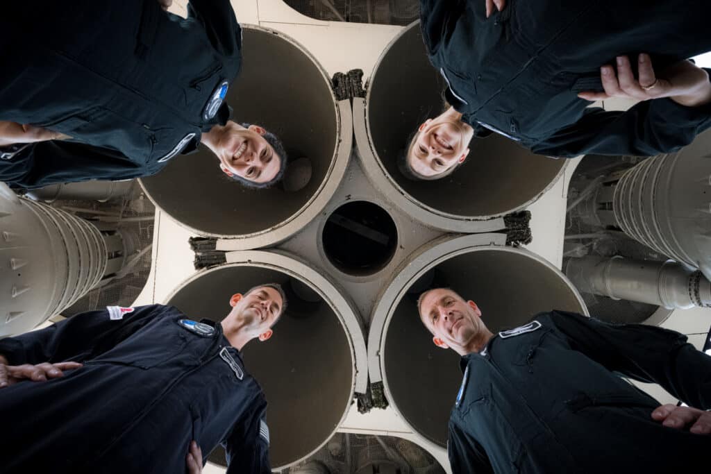 view of four SpaceX crew members from below