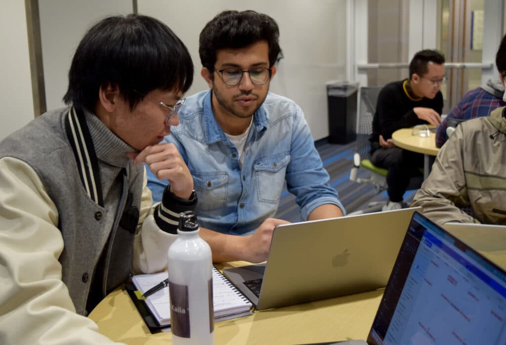 Duke students in classroom working at laptop