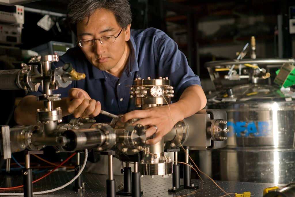 Jungsang Kim working on the inner elements of a quantum computer