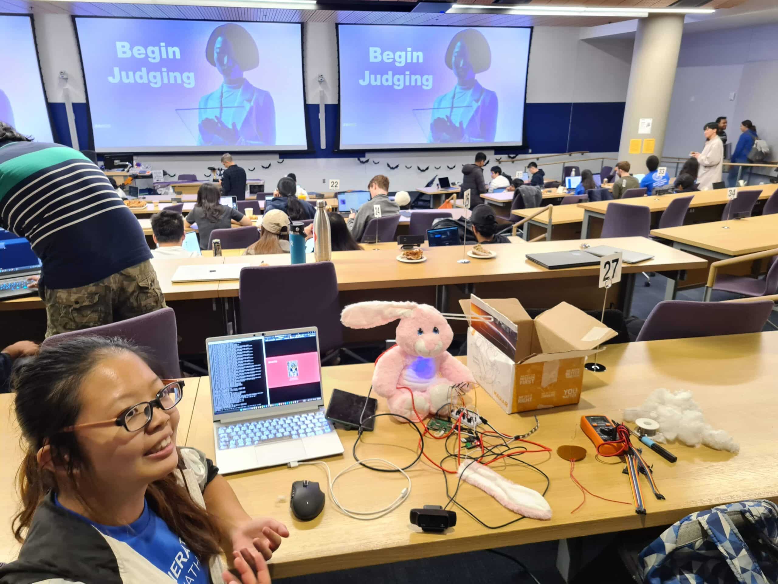 Annabelle Chu, Duke senior in electrical and computer engineering, hacks into her winning entry "BunnyBotBeacon, a robotic plush bunny rabbit that functioned as speaking and listening mental health chatbot.