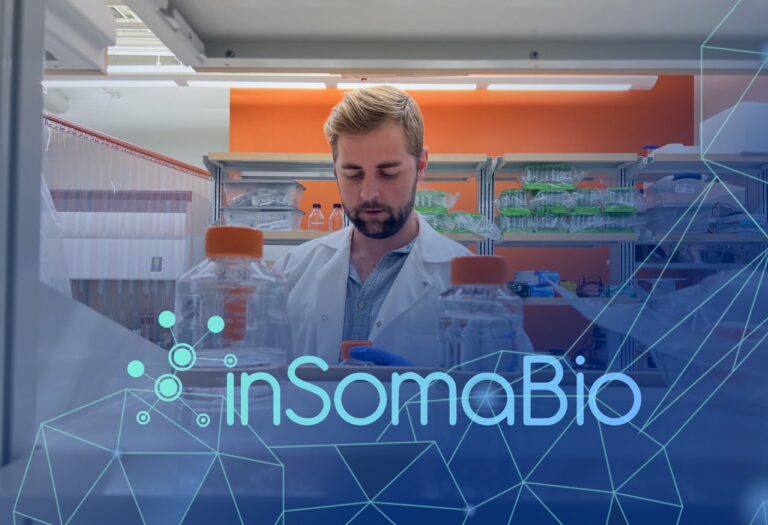man in white lab coat working at a table with inSomaBio logo overtop