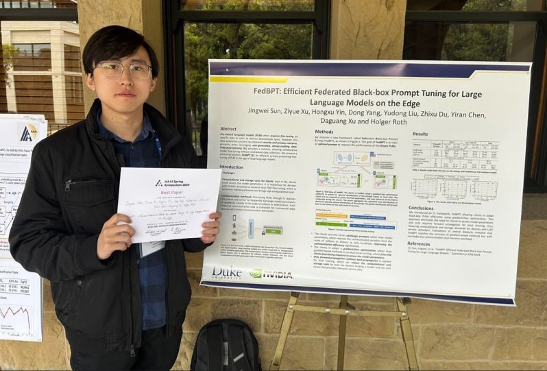 Jingwei Sun stands with research poster