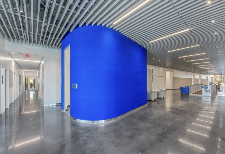 wide view of hallway with pod conference room and stairway