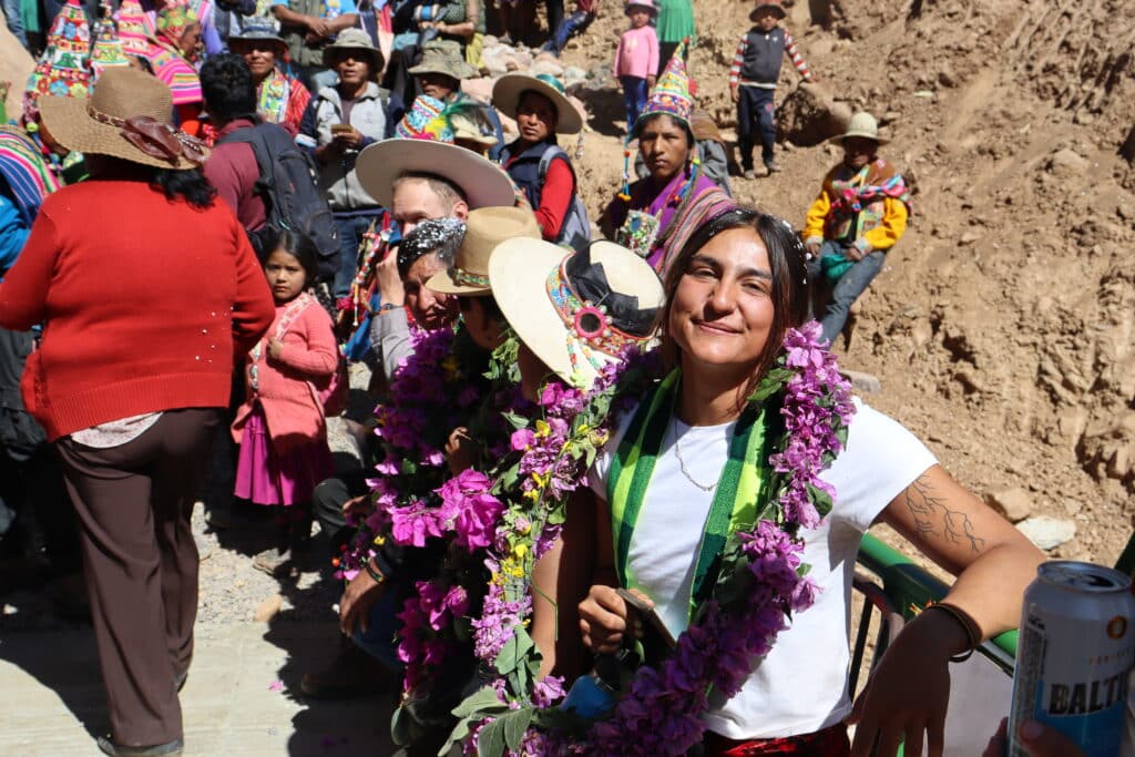 woman in flowers smiling in front of a large group of people