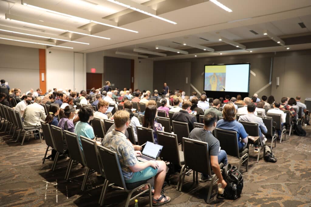 a lecture hall filled with attendees at a soft matter conference 