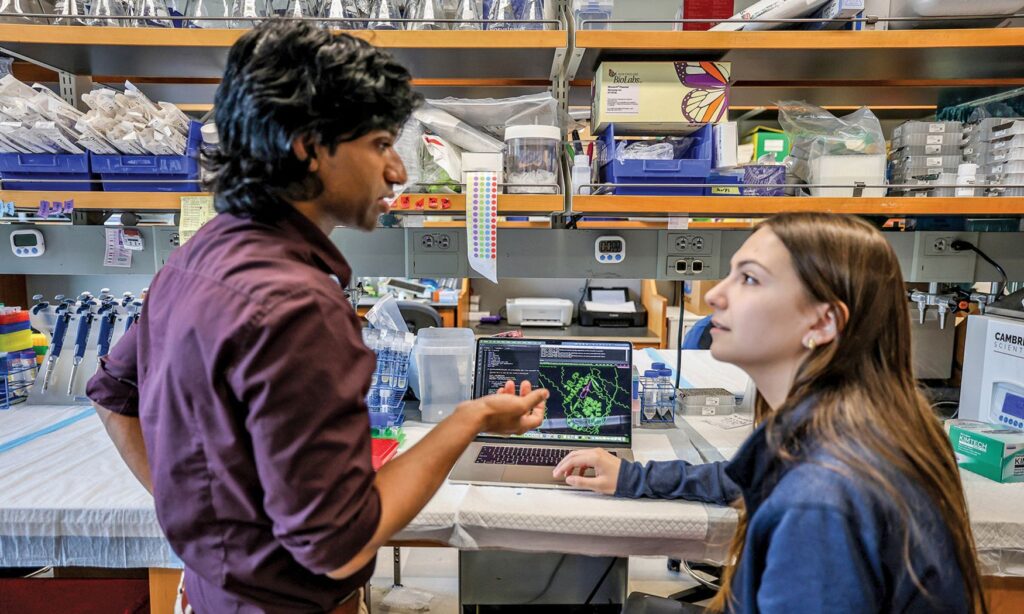 Pranam Chatterjee discusses protein design with a student