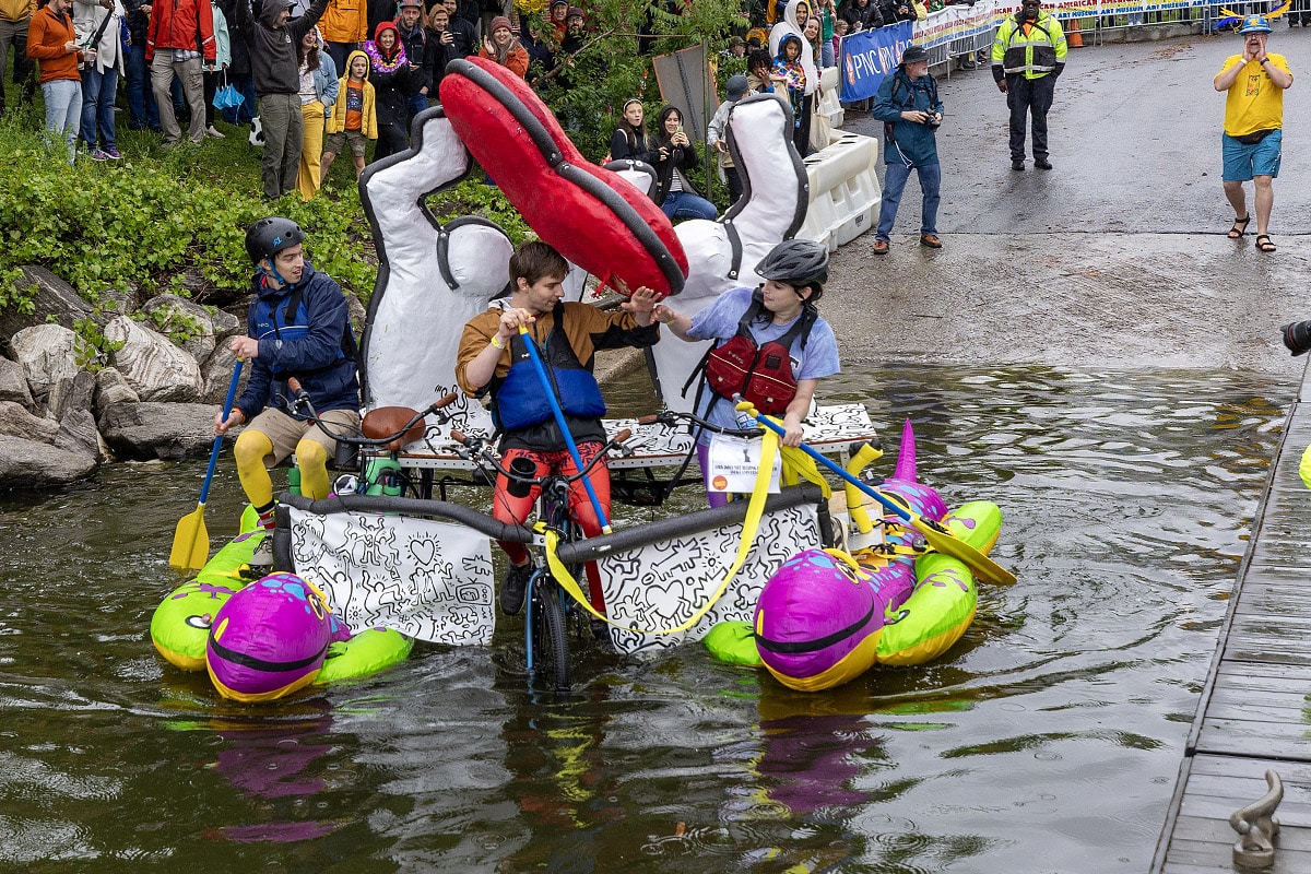 a kinetic structure and artists ford a stream