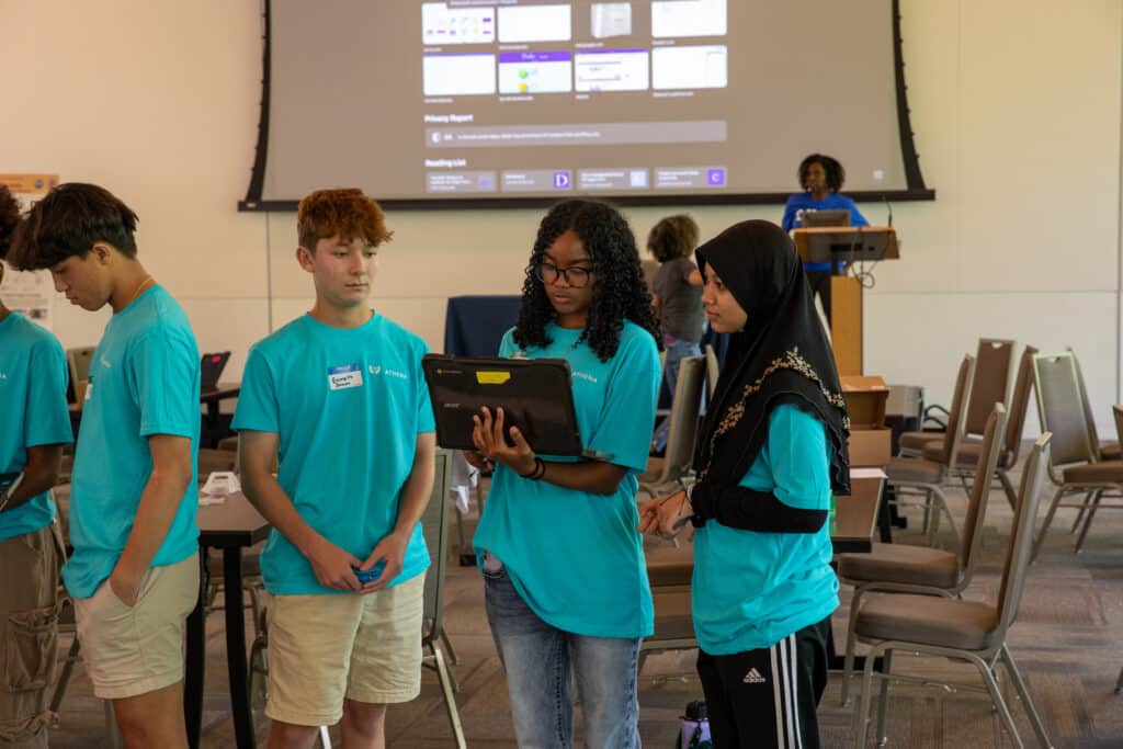 Students work together on a laptop