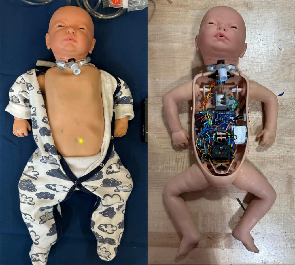 Two photos of a baby manikin side by side. On the left side is a photo of the manikin wearing an open onesie. On the right side is a photo of the manikin with its chest plate removing, revealing a bundle of wires and machinery inside it.