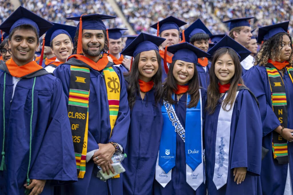 a group of smiling Duke Engineering graduates during the 2025 commencement ceremony