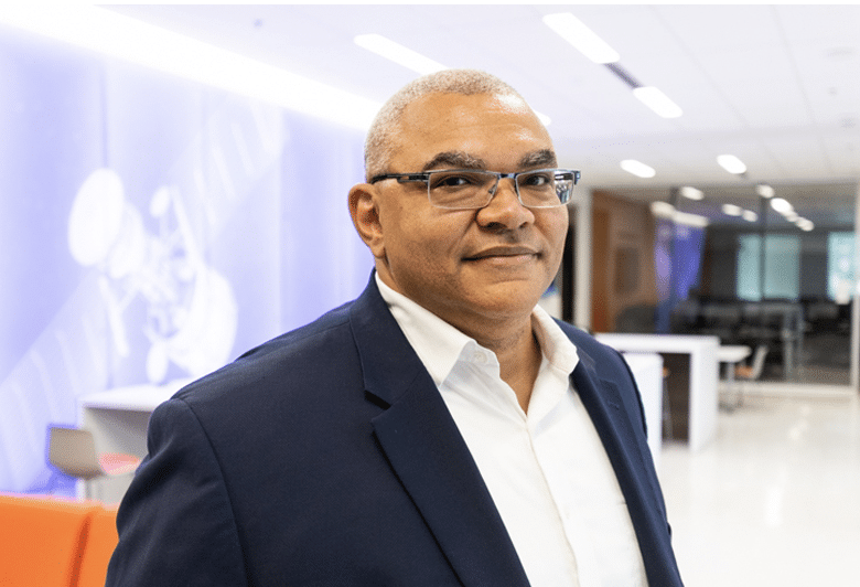 image of professor wearing a suit inside building