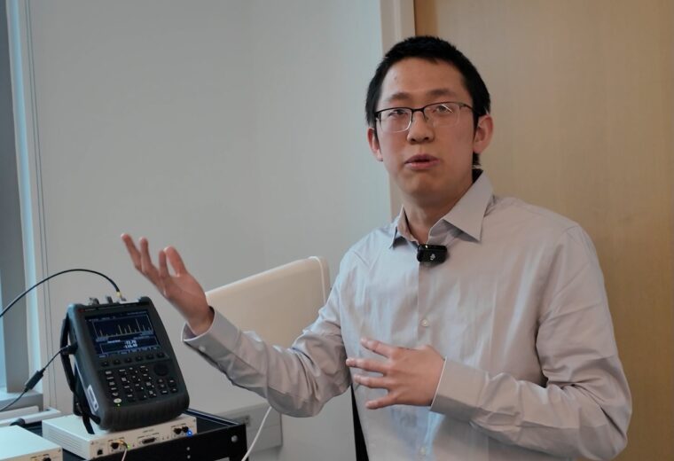 Zhihui Gao explains the WISE setup in the lab.