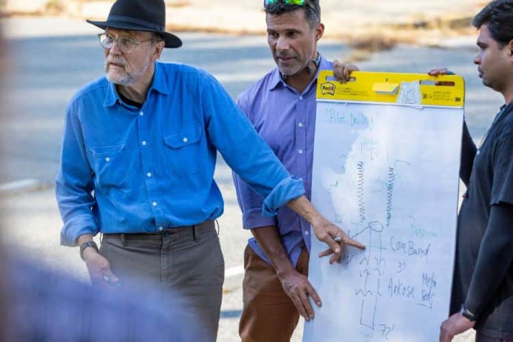 Peter Malin points to a diagram drawn on a giant paper easel while teaching his geothermal class.